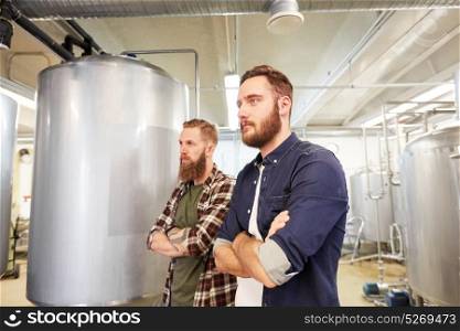 production, business and people concept - men at craft brewery or non-alcoholic beer plant. men at craft brewery or beer plant