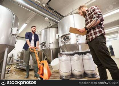 production, business and people concept - men with beer kegs on loader and clipboard working at craft brewery or non-alcoholic beverage plant. men with beer kegs and clipboard at craft brewery