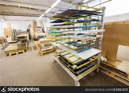 production, manufacture and woodworking industry concept - boards storing at furniture factory workshop. boards storing at woodworking factory workshop. boards storing at woodworking factory workshop