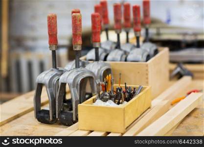 production, manufacture and woodworking industry concept - drills and tools at workshop. drills and woodworking tools at workshop