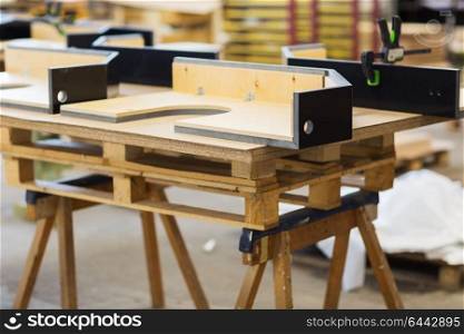 production, manufacture and woodworking industry concept - furniture items on workbench at workshop. furniture items on workbench at workshop