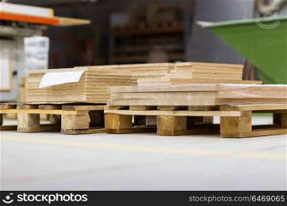 production, manufacture and woodworking industry concept - wooden boards and chipboards storing at furniture factory. wooden boards and chipboards storing at factory