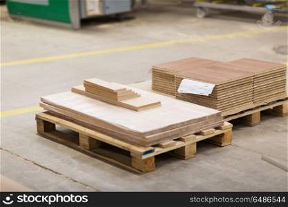 production, manufacture and woodworking industry concept - wooden boards and chipboards storing at furniture factory. wooden boards and chipboards storing at factory. wooden boards and chipboards storing at factory