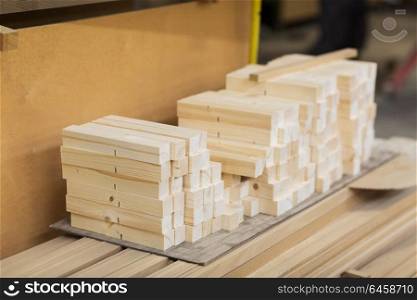 production, manufacture and woodworking industry concept - wooden boards at workshop or storehouse. wooden boards at workshop or woodworking plant