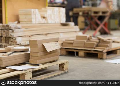 production, manufacture and woodworking industry concept - wooden or mdf boards at workshop. wooden boards at workshop or woodworking plant