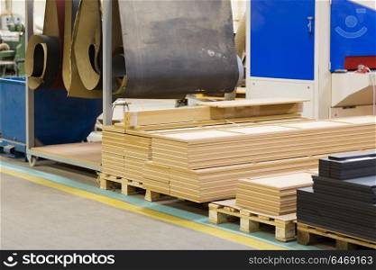production, manufacture and woodworking industry concept - wooden or mdf boards at workshop. wooden boards at workshop or woodworking plant