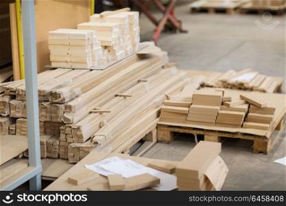 production, manufacture and woodworking industry concept - wooden or medium density fibreboards at workshop. wooden boards or fibreboards at woodworking plant