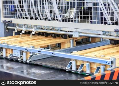 Production of wooden pallets on a modern automatic line for woodworking.. Production of wooden pallets on an automatic line.