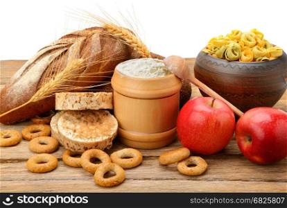 Products made of wheat on table isolated on white background