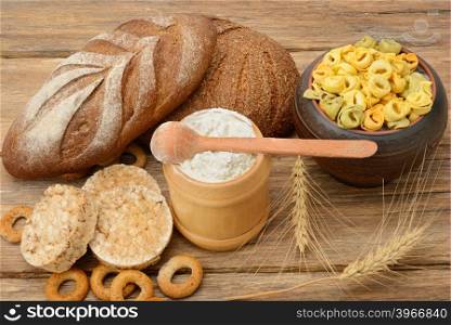 Products made of wheat on wooden table.