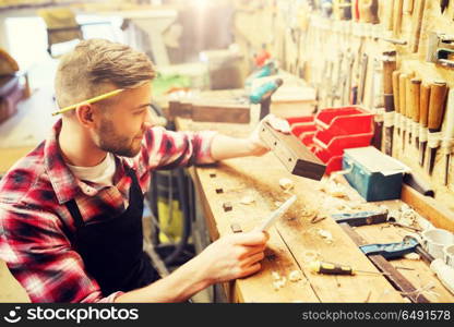 profession, carpentry, woodwork and people concept - carpenter working with wood plank at workshop. carpenter working with wood plank at workshop. carpenter working with wood plank at workshop