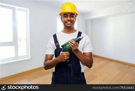 profession, construction and building concept - happy smiling indian repairman or builder in helmet with electric drill or perforator over empty room background. happy indian builder in helmet with electric drill