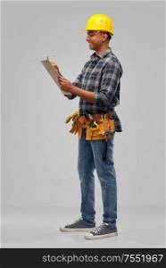 profession, construction and building - happy indian worker or builder in helmet with clipboard and pencil over grey background. happy builder with clipboard and pencil