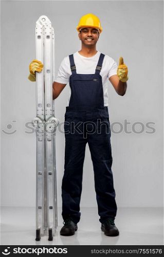 profession, construction and building - happy smiling indian builder in helmet with ladder showing thumbs up over grey background. happy indian builder with ladder showing thumbs up