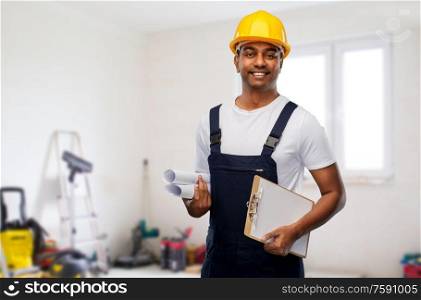 profession, construction and building - happy smiling indian builder in helmet with blueprint and clipboard over home or apartment room background. happy indian builder with blueprint and clipboard