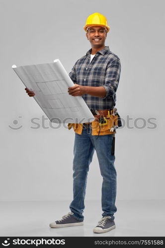 profession, construction and building - happy smiling indian builder in helmet with blueprint over grey background. happy indian builder in helmet with blueprint