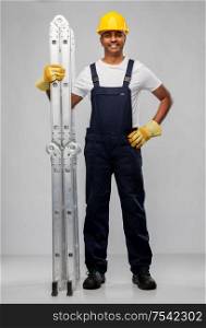 profession, construction and building - happy smiling indian builder in helmet with ladder over grey background. happy indian builder in helmet with ladder