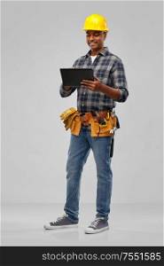 profession, construction and building - happy smiling indian worker or builder in helmet with tablet pc computer over grey background. happy indian builder in helmet with tablet pc