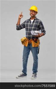 profession, construction and building - happy smiling indian worker or builder in helmet with tool belt having idea over grey background. happy indian builder in helmet with tool belt