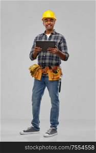 profession, construction and building - happy smiling indian worker or builder in helmet with tablet pc computer over grey background. happy indian builder in helmet with tablet pc