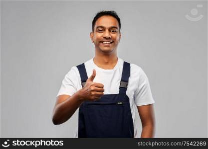 profession, construction and building - happy smiling indian worker or builder showing thumbs up over grey background. happy indian worker or builder showing thumbs up