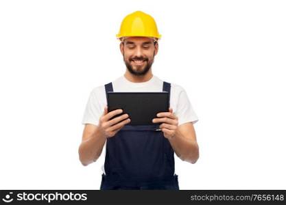profession, construction and building - happy smiling male worker or builder in yellow helmet and overall with tablet pc computer over white background. happy male worker or builder with tablet computer
