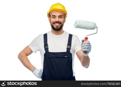 profession, construction and building - happy smiling male worker or builder in yellow helmet and overall with paint roller over white background. male worker or builder with paint roller