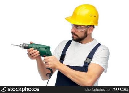 profession, construction and building - male worker or builder in helmet and goggles with drill over white background. male worker or builder in helmet with drill