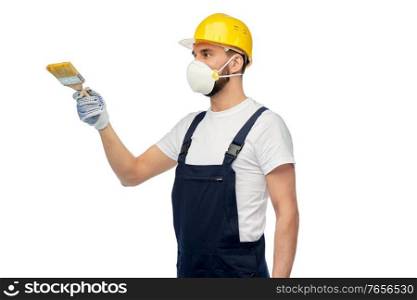 profession, construction and building - male worker or builder in yellow helmet and respirator with brush over white background. worker or builder in respirator with brush