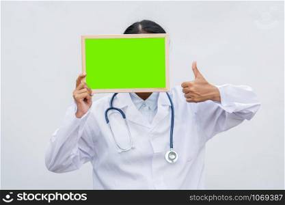 profession doctor in white coat over white isolated background with white blank board and Thumbs up. Concept of healthcare, science and medicine concept
