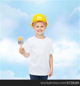 profession, future, childhood and people concept - smiling little boy in protective helmet with paint brush