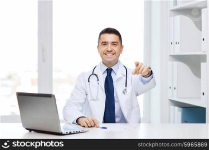 profession, gesture, people, technology and medicine concept - smiling male doctor in white coat pointing finger at you in medical office