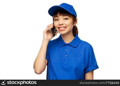 profession, job and people concept - happy smiling delivery woman in blue uniform calling on smartphone over white background. happy smiling delivery woman calling on smartphone