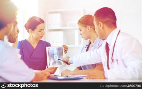 profession, people, surgery, radiology and medicine concept - group of doctors with x-ray on tablet pc computer screen meeting at medical office