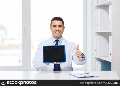 profession, people, technology, advertisement and medicine concept - smiling male doctor in white coat showing thumbs up gesture and tablet pc computer blank screen in medical office