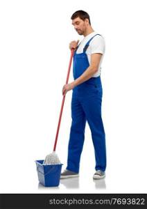profession, service and people concept - male worker or cleaner in overall cleaning floor with wet mop and bucket over white background. male cleaner cleaning floor with mop and bucket
