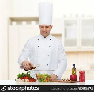 profession, vegetarian, food and people concept - happy male chef cooking salad over kitchen background