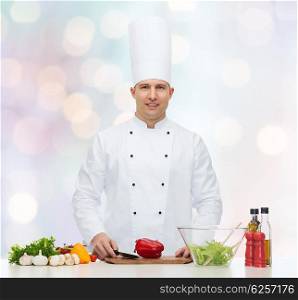 profession, vegetarian, food and people concept - happy male chef cooking vegetable salad over blue lights background