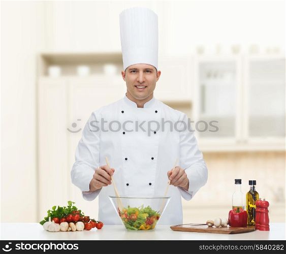 profession, vegetarian, food and people concept - happy male chef cooking vegetable salad over kitchen background