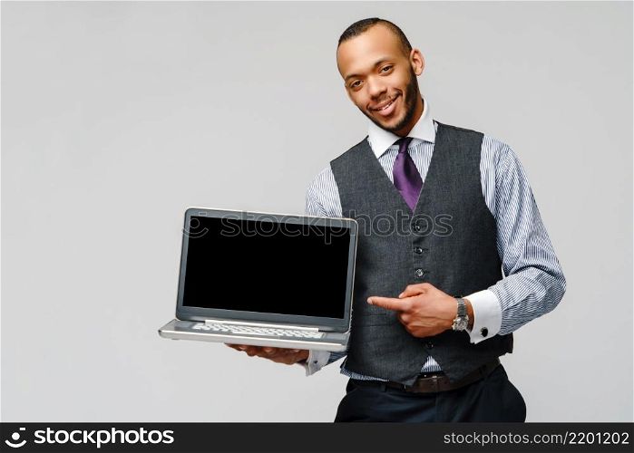 professional african-american business man holding laptop computer.. professional african-american business man holding laptop computer
