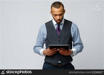 professional african-american business man holding tablet pc.. professional african-american business man holding tablet pc