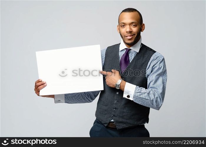 professional african-american business man - presenting holding blank sign.. professional african-american business man - presenting holding blank sign