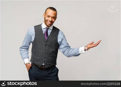 professional african-american business man - presenting points a hand at copy space.. professional african-american business man - presenting points a hand at copy space