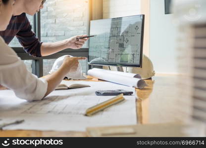 professional architect designer structural engineer team colleagues working office looking computer discussing building plan design project