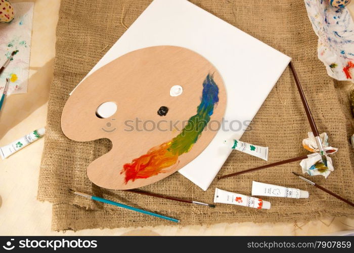 Professional artist tools and paints lying on table at working studio