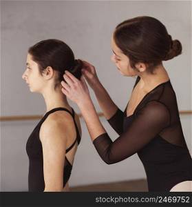 professional ballet dancers getting their hairdo ready