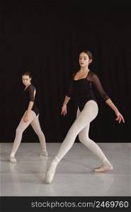 professional ballet dancers practicing together while wearing pointe shoes