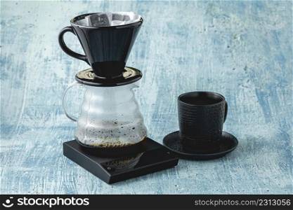 Professional barista brews coffee with pour over method. Alternative ways of brewing coffee. Coffee shop concept.