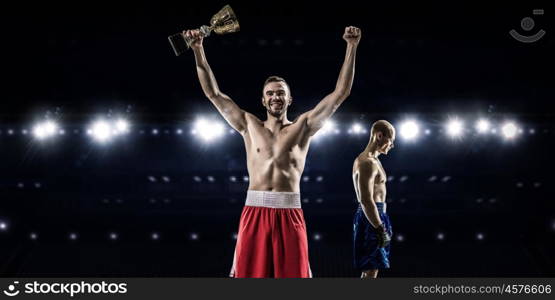 Professional box match. Two professional boxers fighting on arena in spotlights mixed media