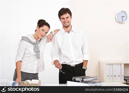 Professional businessman and businesswoman at the office working together